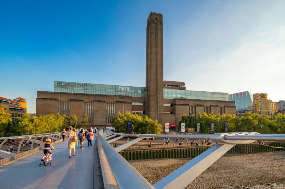 a group of people walking on Tate Modern