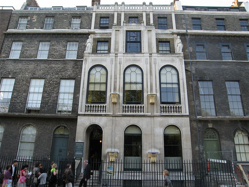 a group of people standing in front of a tall building with Sir John Soane's Museum in the background