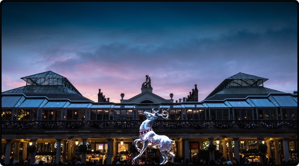 a statue of a deer in front of a covered market