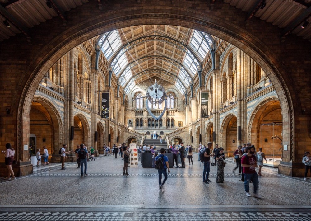 a group of people standing in front of Natural History Museum