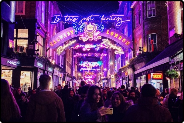 a crowd of people walking in front of a store