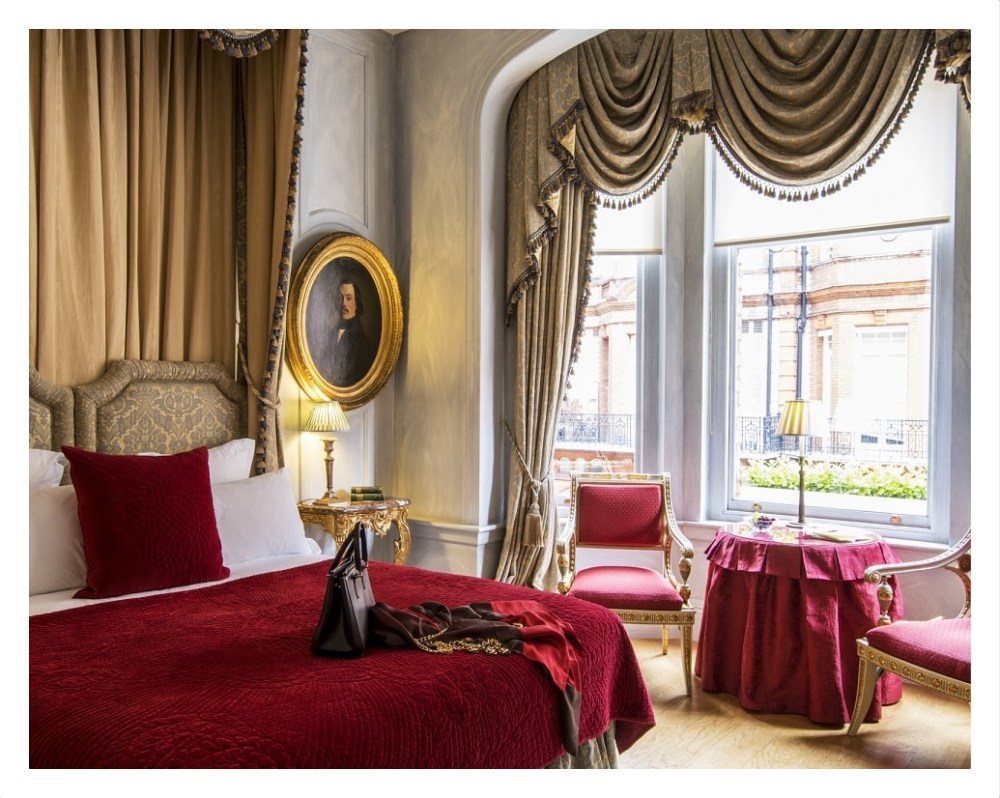 a bedroom with a bed and a chair in a room