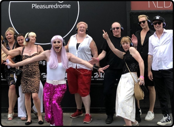 a group of people standing in front of a crowd posing for the camera