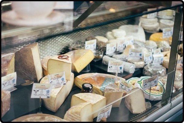 a glass display case with many different types of food