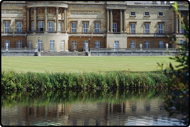 a castle with water in front of a building